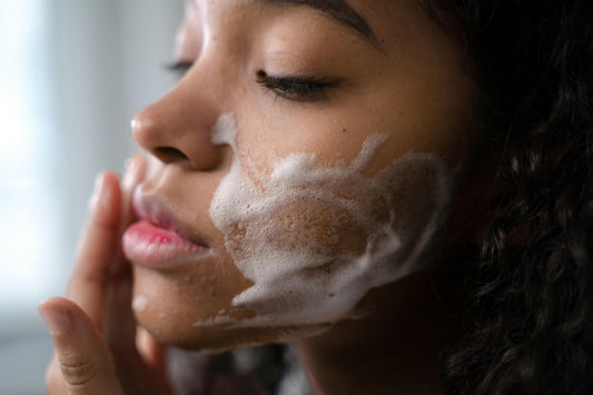 woman applying nature skincare products on her face