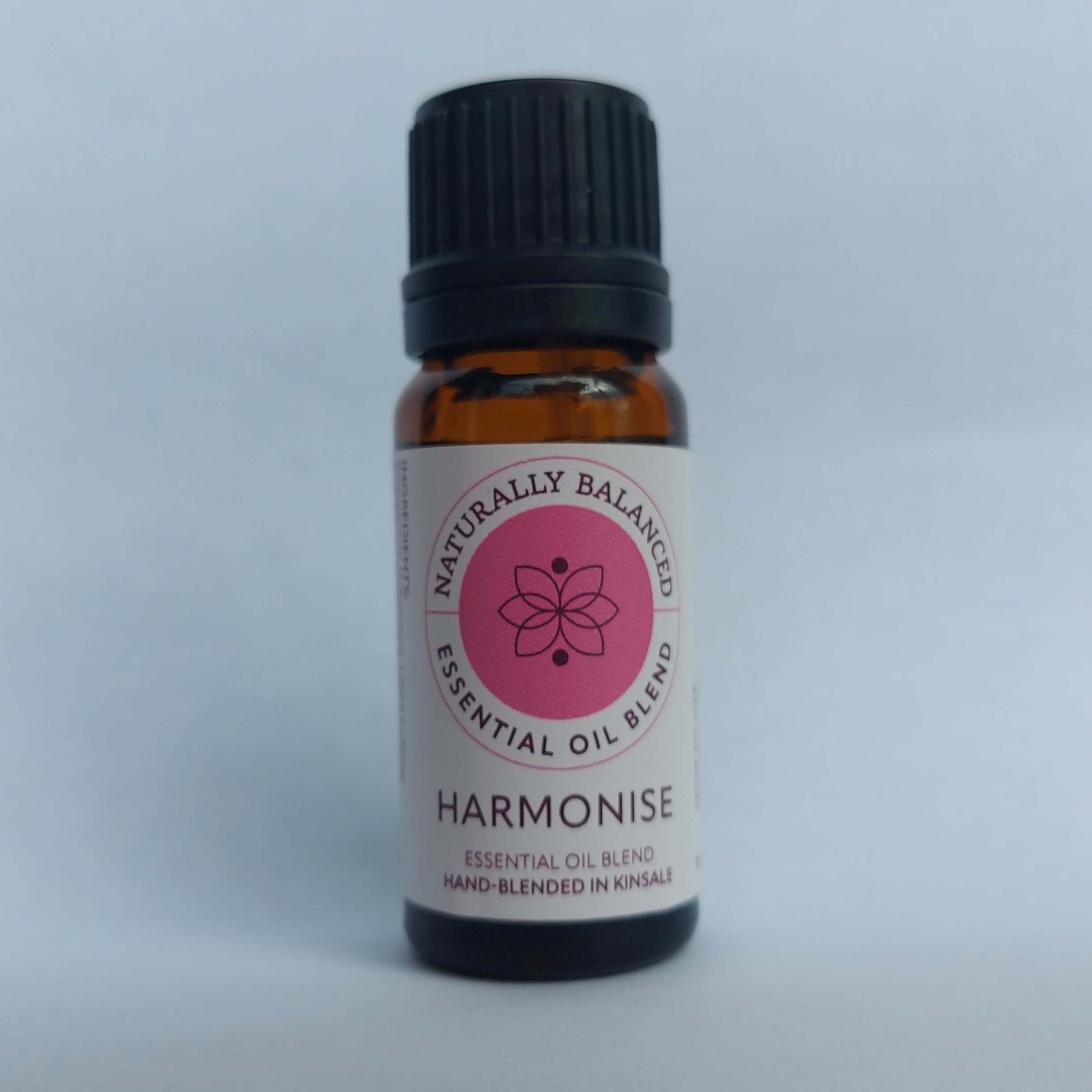 Essential oil blend bottle labeled 'Harmonise' on a light gray background