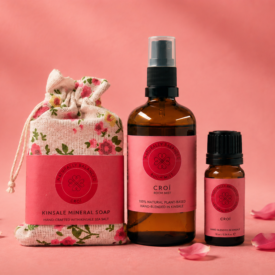 Cosmetic products including a soap bag, bottles, and a spray bottle on a pink background