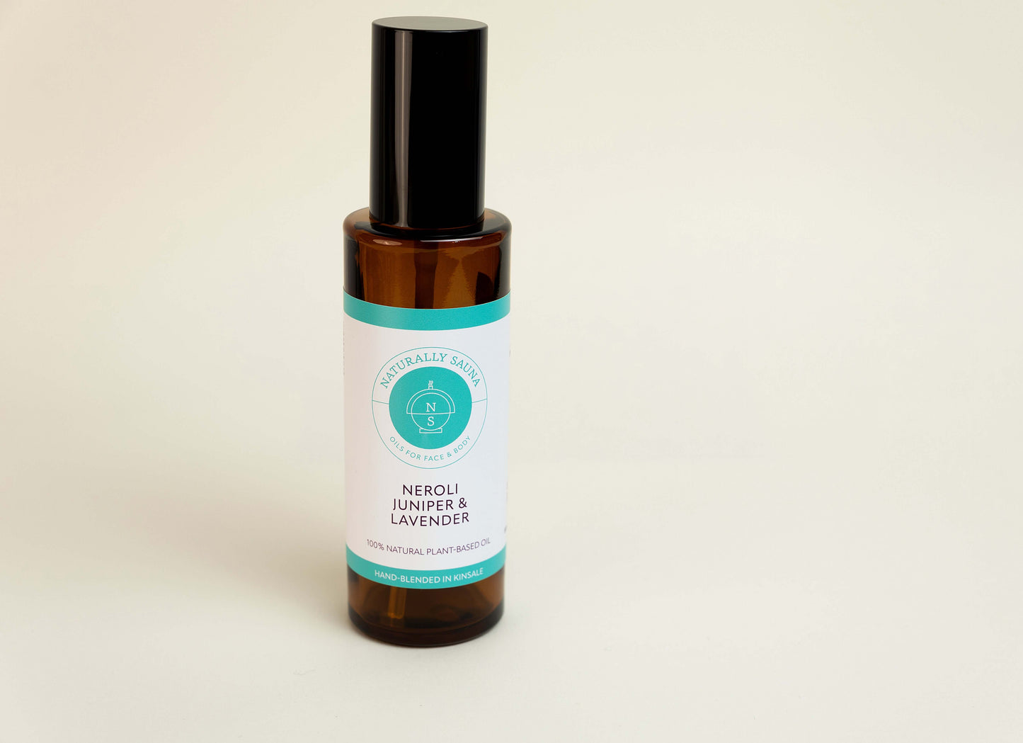 Bottle of Neroli Juniper & Lavender essential oil on a light background