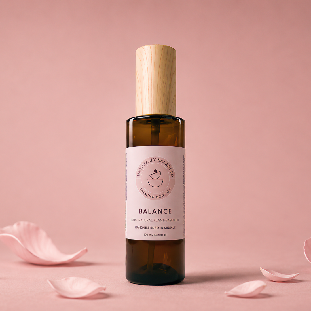 Bottle of 'Balance' with rose petals on a pink background