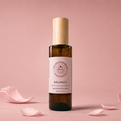 Bottle of 'Balance' with rose petals on a pink background