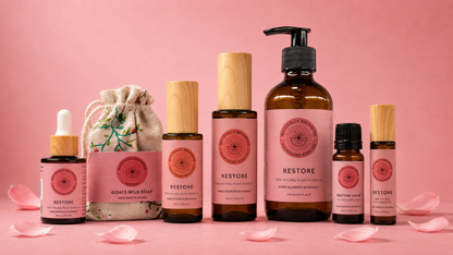 Collection of skincare products with 'Restore' branding on a pink background