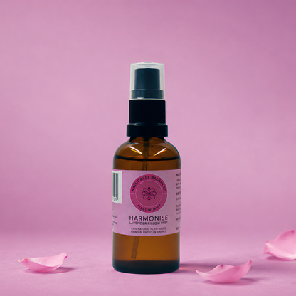 Bottle of Harmonist product with pink petals on a pink background