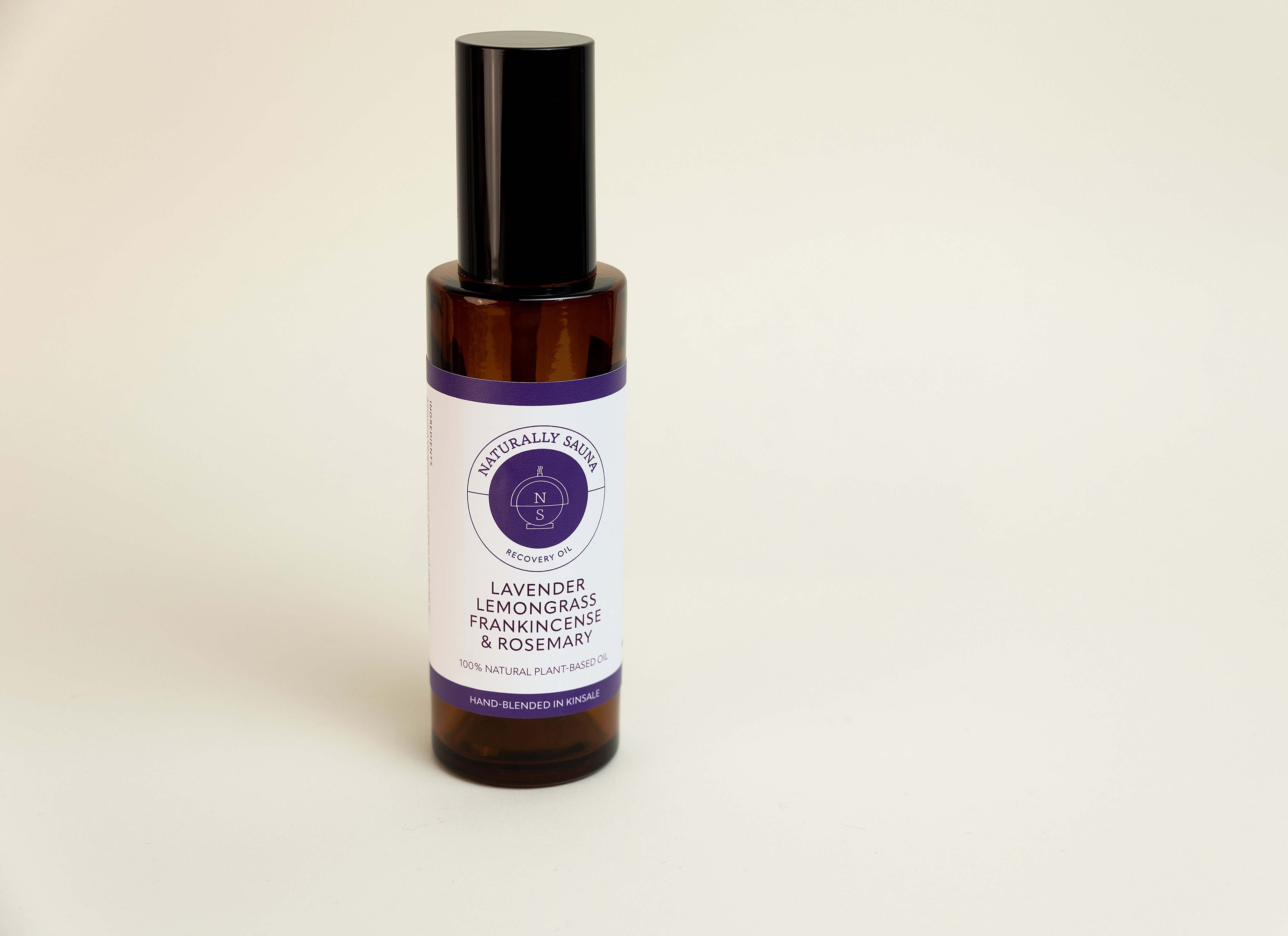 Bottle of lavender lemon grass frankincense and myrrh essential oil on a light background