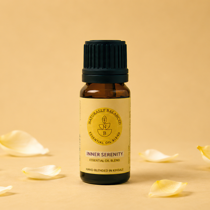 Bottle of Inner Serenity essential oil with petals on a beige background