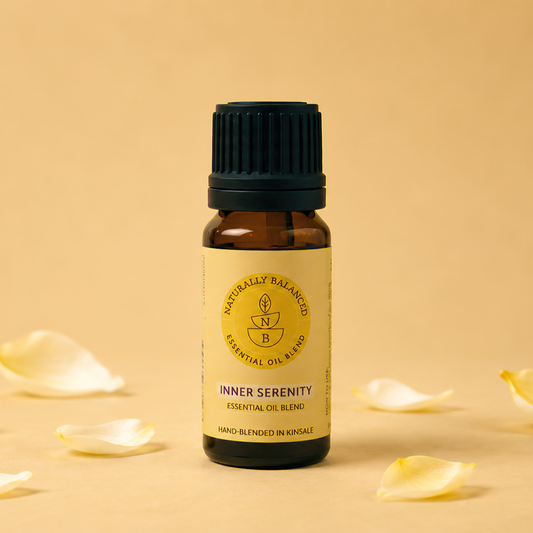 Bottle of Inner Serenity essential oil with petals on a beige background