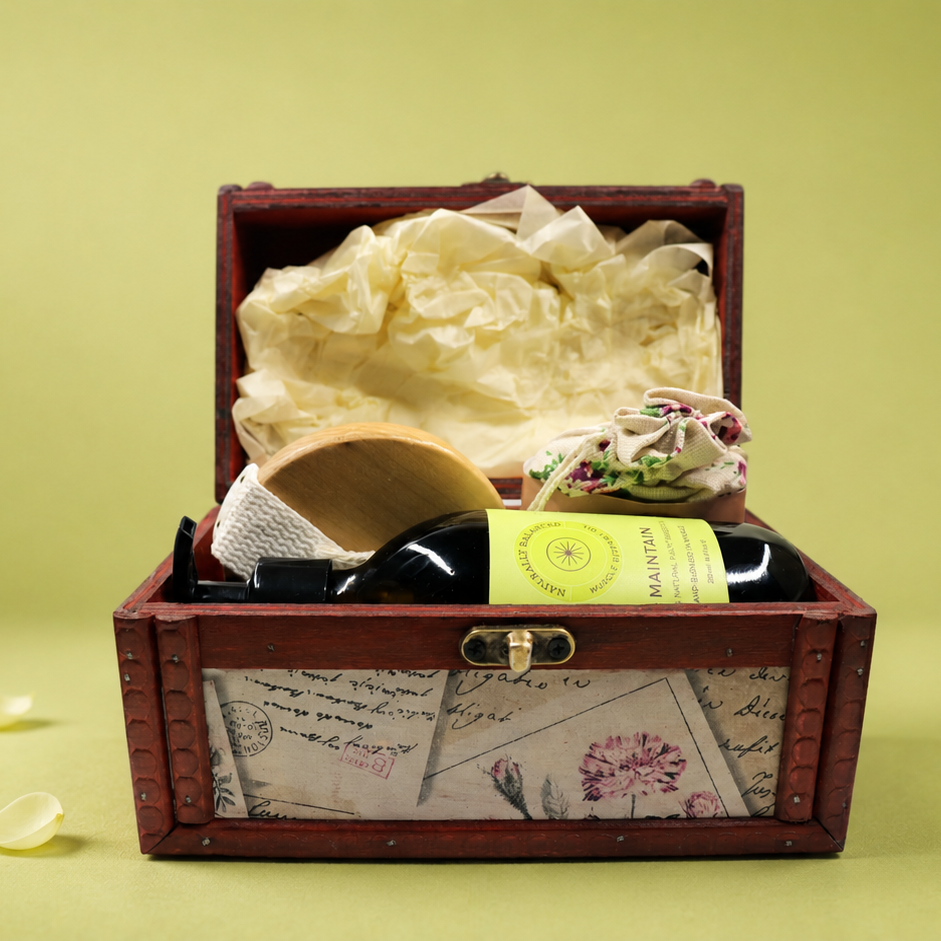 Wooden treasure chest with a bottle of wine and decorative items on a green background