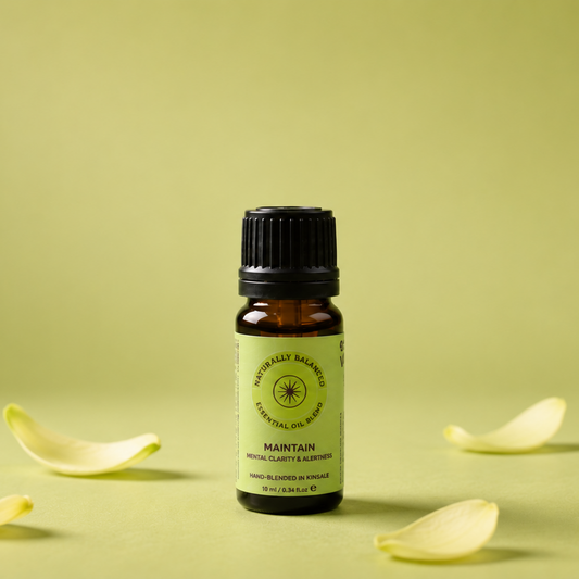 Small bottle of essential oil with flower petals on a light green background