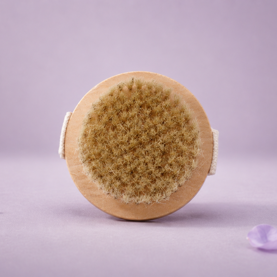 Round natural brush on a light purple background with scattered petals.
