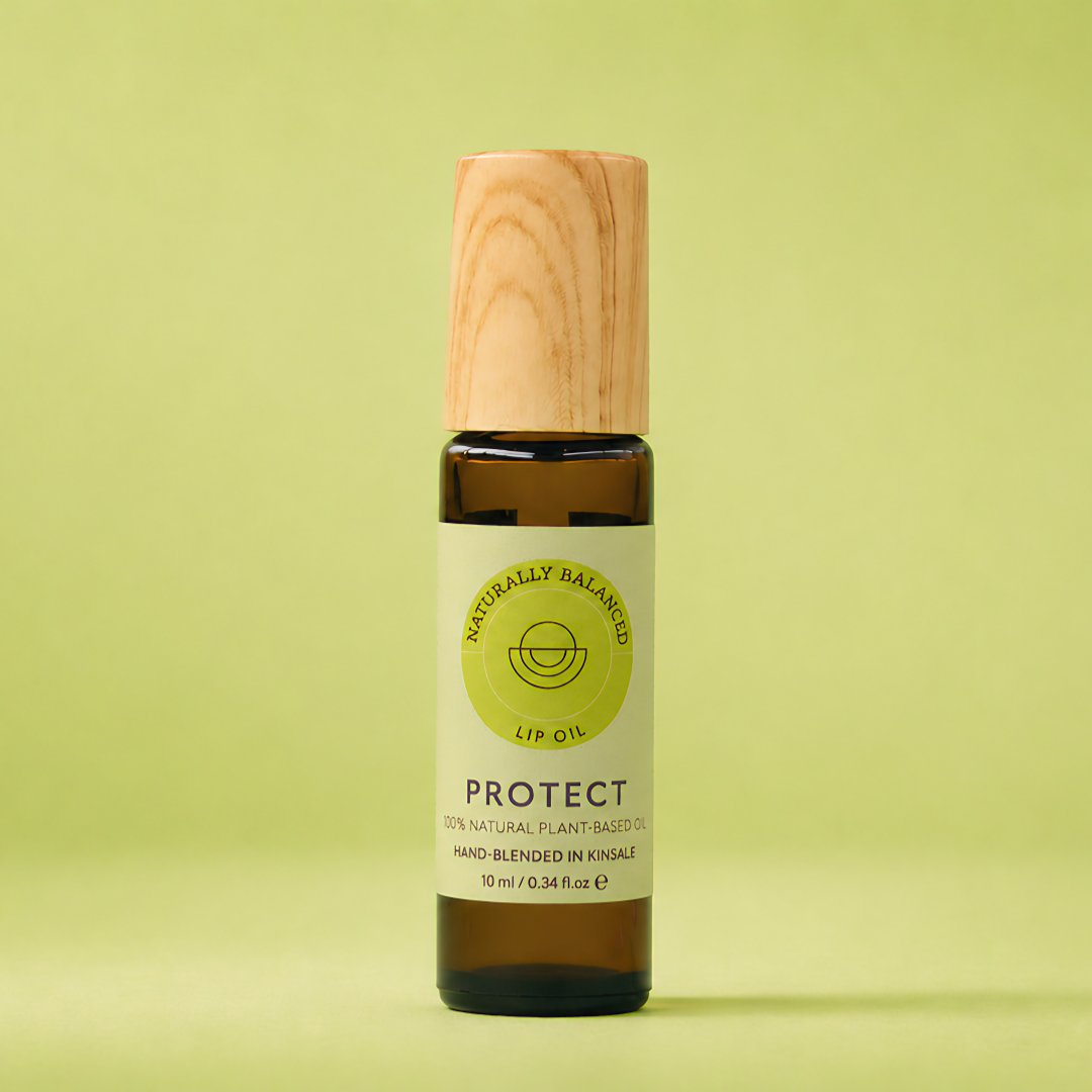 Bottle of lip balm with wooden cap on a light green background