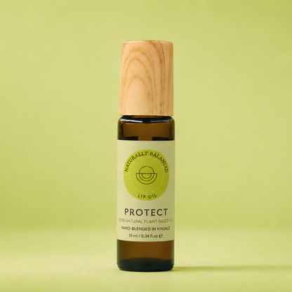 Bottle of lip balm with wooden cap on a light green background