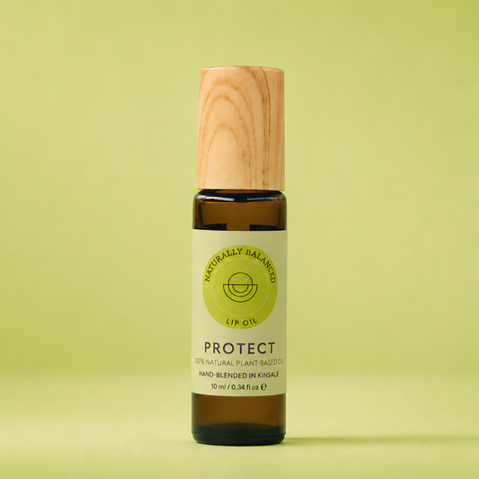 Bottle of lip balm with wooden cap on a light green background