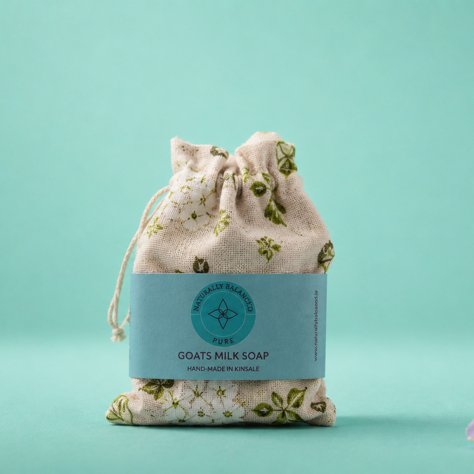 Bar of soap in a drawstring bag on a teal background